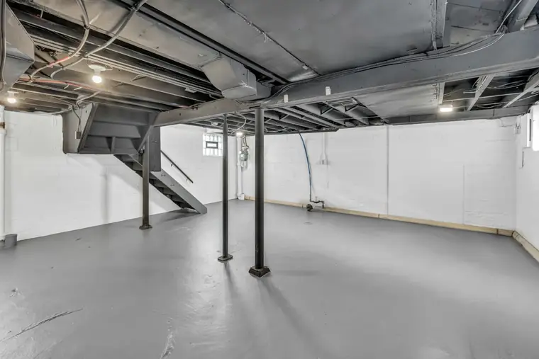 Clean unfinished basement with painted block walls