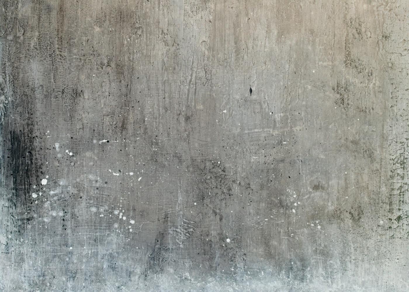 Grey concrete wall with pale mineral staining and water marks